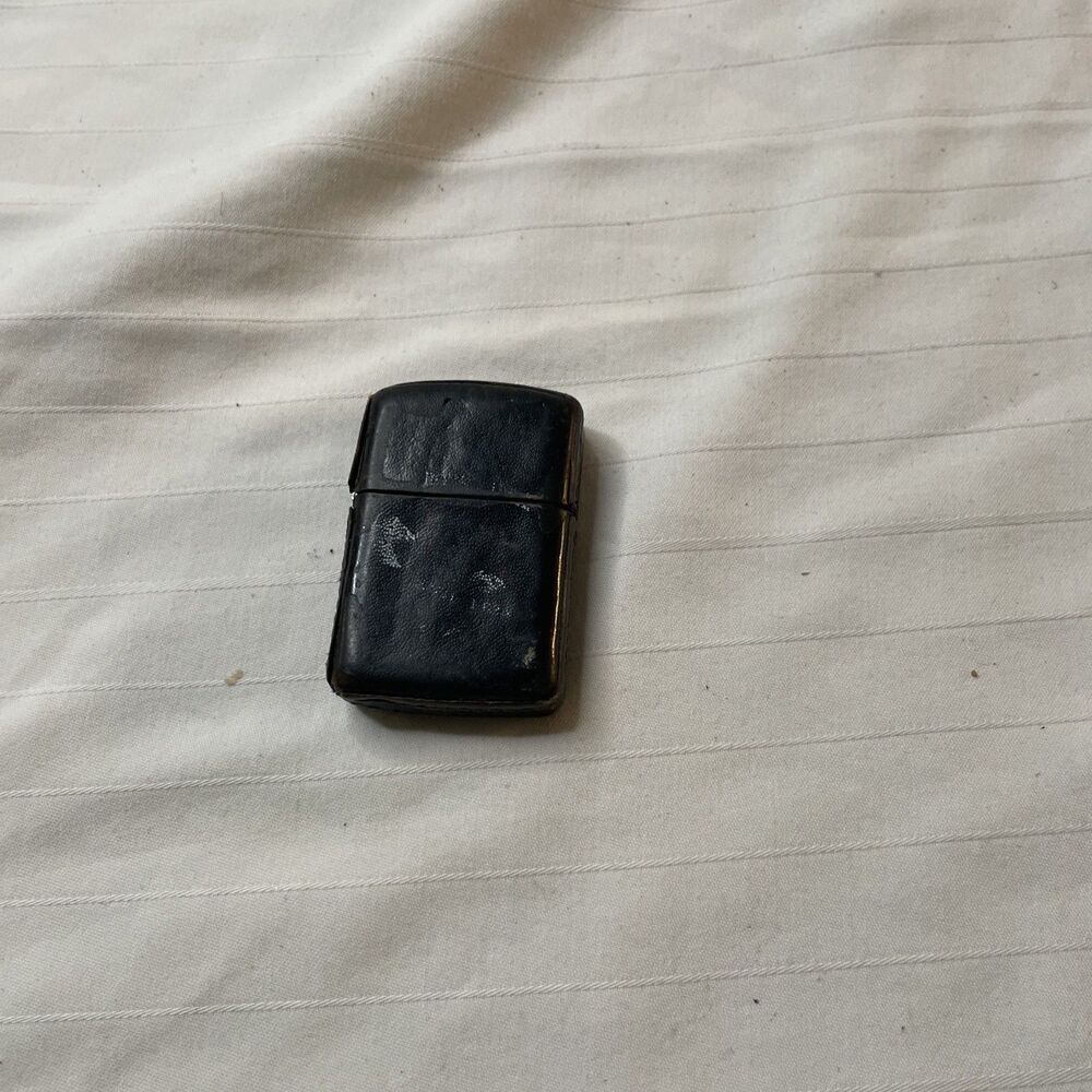 Vintage leather bound zippo lighter graphics worn off